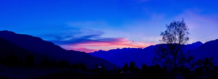 Scenic view of silhouette mountains against sky at sunset