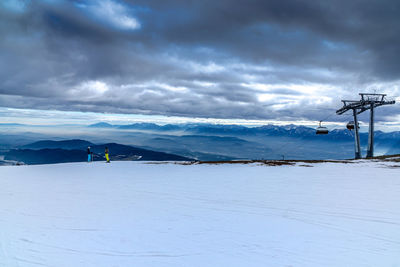 Scenic view of snow covered field against sky