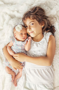 High angle view of young woman lying on bed at home