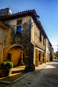 Street amidst buildings against sky in city