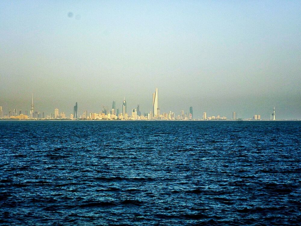 sea, water, waterfront, architecture, built structure, building exterior, city, copy space, clear sky, cityscape, rippled, urban skyline, sky, mid distance, scenics, tranquil scene, skyscraper, tranquility, nature, travel destinations