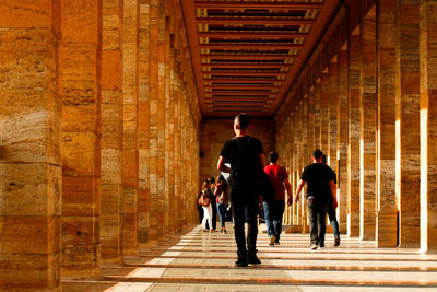 Rear view of people walking in college campus