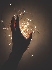 Close-up of hand holding illuminated light