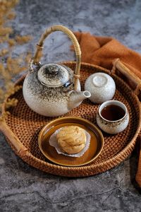 Choux pastry with tea set in a basket