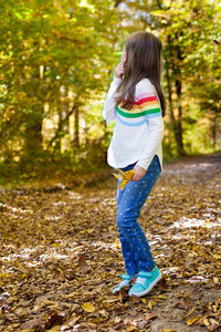 Full length of woman standing on land during autumn