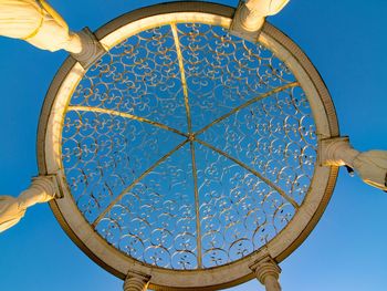 Low angle view of ornate ceiling against clear blue sky