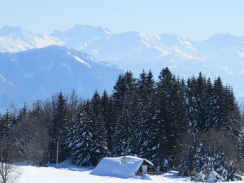Scenic view of snow covered mountains against sky