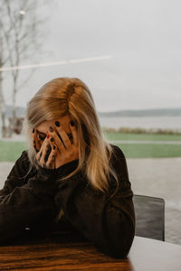 Side view of young woman looking away, depression, mental health