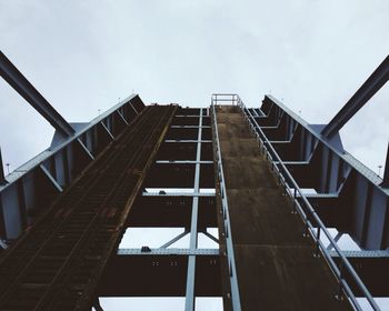 Low angle view of elevated walkway against sky