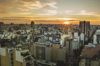 High angle view of cityscape against cloudy sky