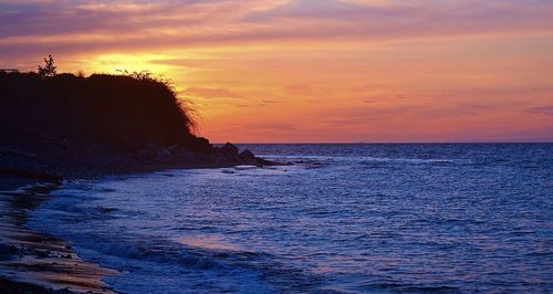 Scenic view of sea at sunset