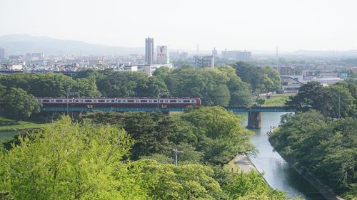 High angle view of bridge over river in city against sky