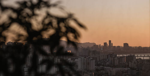 City buildings against sky during sunset