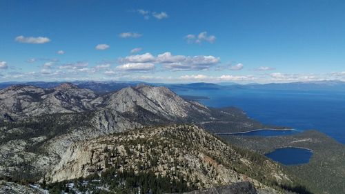 Idyllic shot of mountains and sea against sky