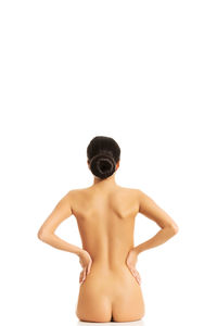 Rear view of shirtless man against white background