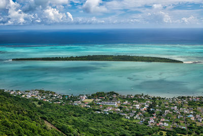 High angle view of townscape by sea against sky