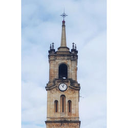 Low angle view of clock tower against sky