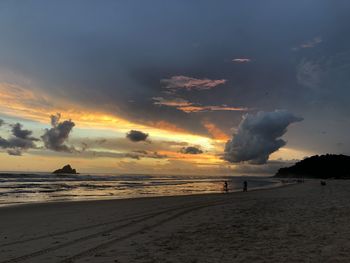 Scenic view of beach against sky during sunset