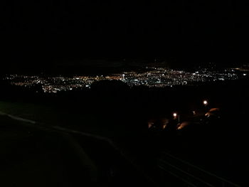 High angle view of illuminated city buildings at night