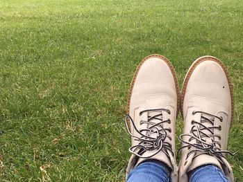 Low section of woman sitting on grass