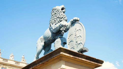 Low angle view of statue against blue sky