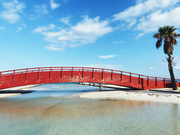 Bridge over swimming pool against sky