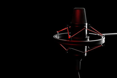 Close-up of microphone against black background