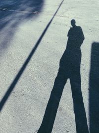 Shadow of person on road