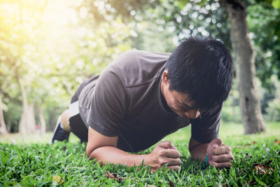 Man doing push ups on field