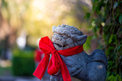 Close-up of red statue against blurred background