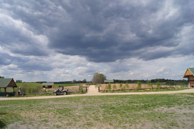 Cloudy sky over grassy field