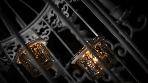 Close-up of illuminated electric lamp against black background