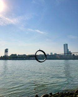 View of city by sea against sky