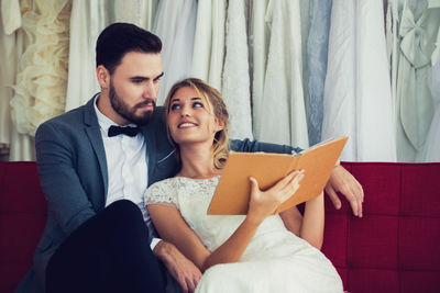 Young couple sitting outdoors