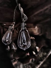 Close-up of light bulb hanging on metal