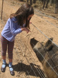 Man wearing horse standing on field