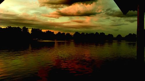 Scenic view of lake against cloudy sky