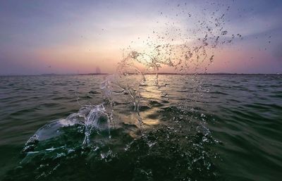 Close-up of sea against sky during sunset