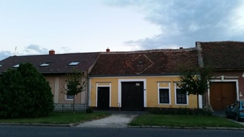 Facade of house against cloudy sky