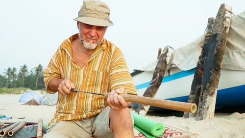 Portrait of man holding umbrella