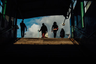Rear view of silhouette people standing on staircase