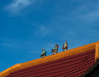 Low angle view of building roof against sky