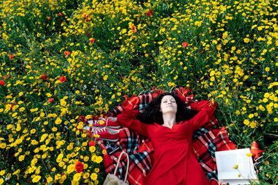 Full length of woman with red flowers