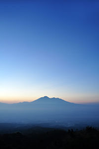 Scenic view of silhouette mount gede against sky during sunrise