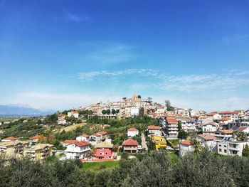 High angle view of townscape against blue sky