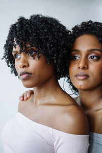 Portrait of two women of color hugging each other