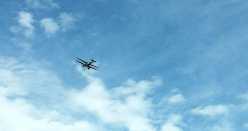 Low angle view of airplane flying in sky