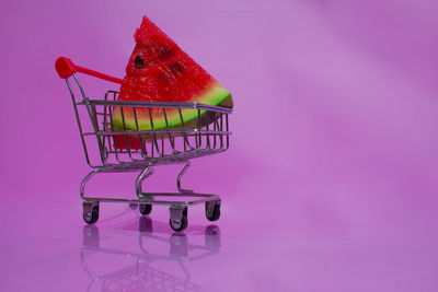 Studio shot of apple against pink background