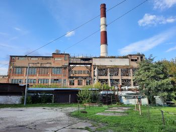 Abandoned factory against blue sky