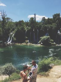 People in park against sky on sunny day